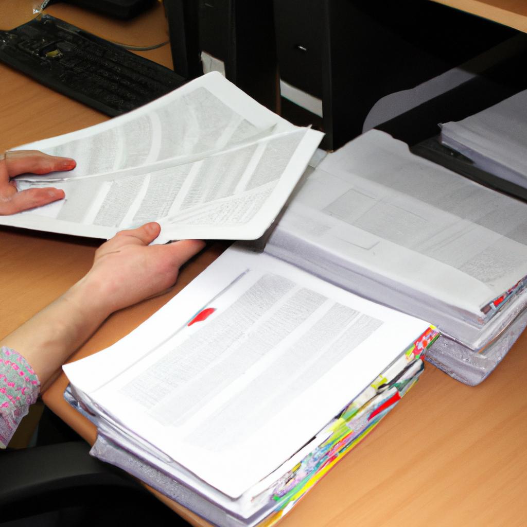 Person analyzing documents in office
